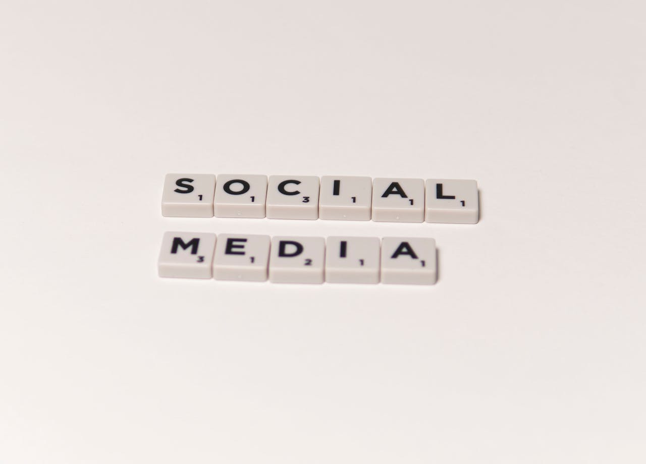 Scrabble tiles spelling 'social media' on a white background, representing digital communication concepts.
